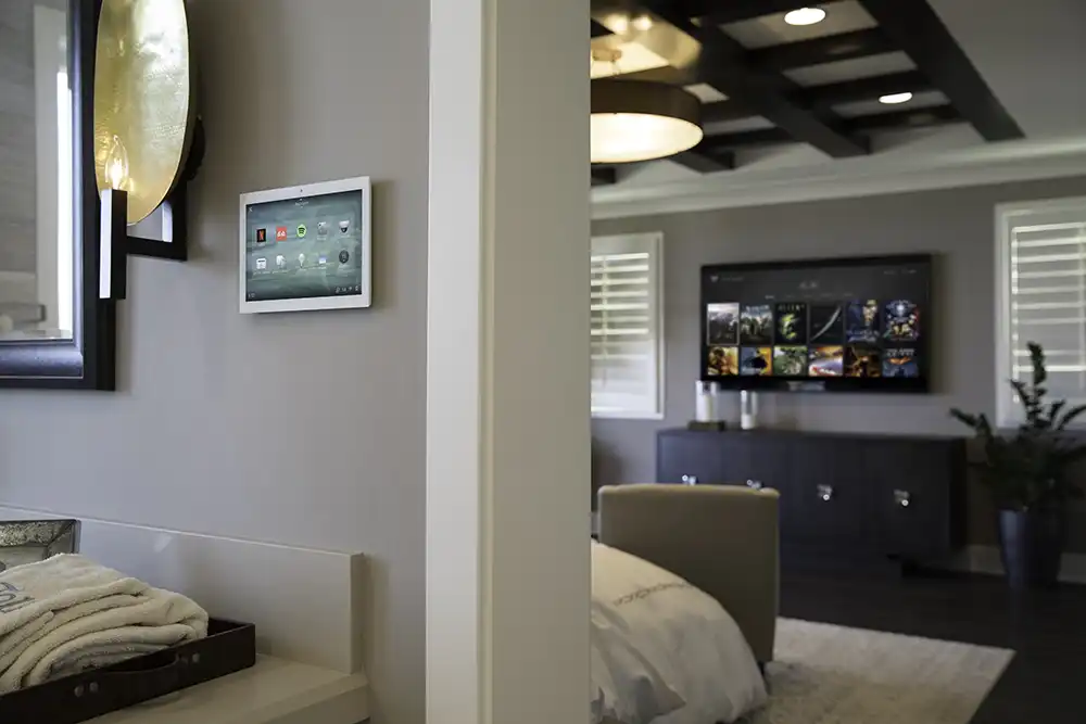A bedroom with a tv mounted on the wall of a Chicago North Shore home.