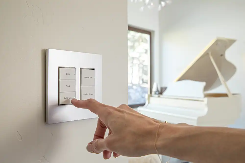 A person pressing a button on a light switch to process home automation tasks for a Chicago North Shore luxury home.