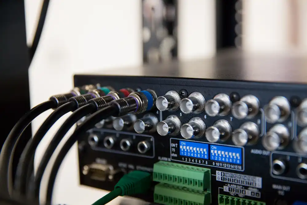 A close up of a tv set with several wires connected to it in a Chicago North Shore luxury home.