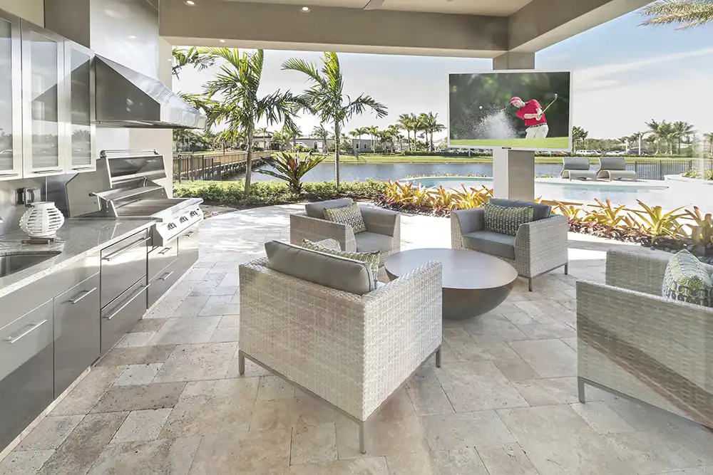 An outdoor living area with a tv and a grill of a Chicago North Shore home.